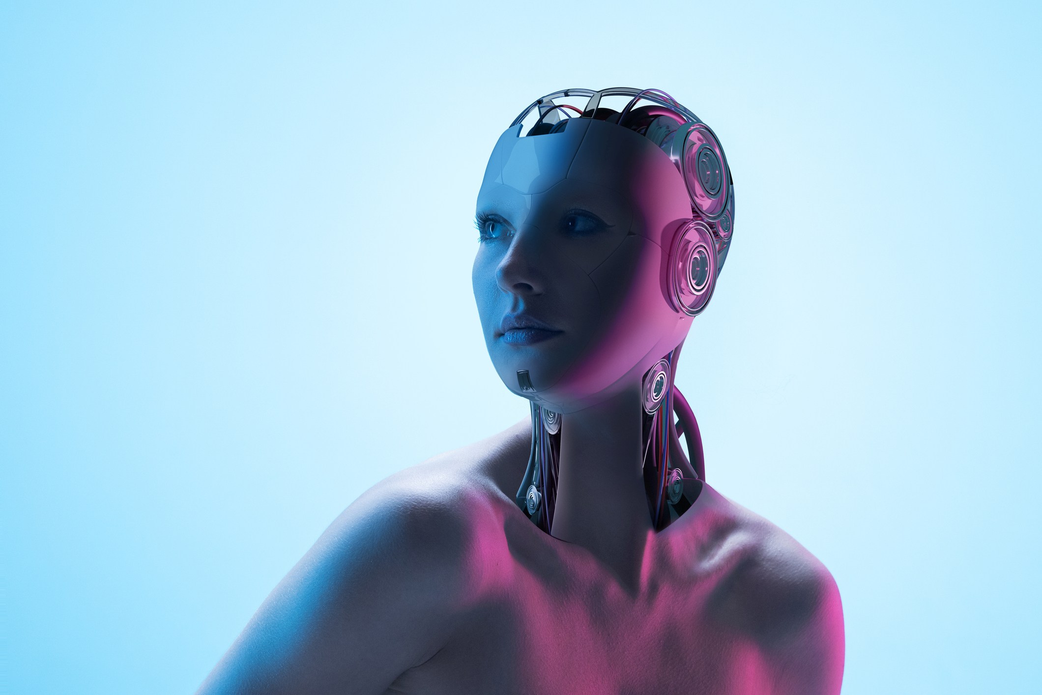 Composite image made of woman's portrait and 3D model of robot cyborg head with panels reflecting neon pink-blue lighting against futuristic cyan background. 