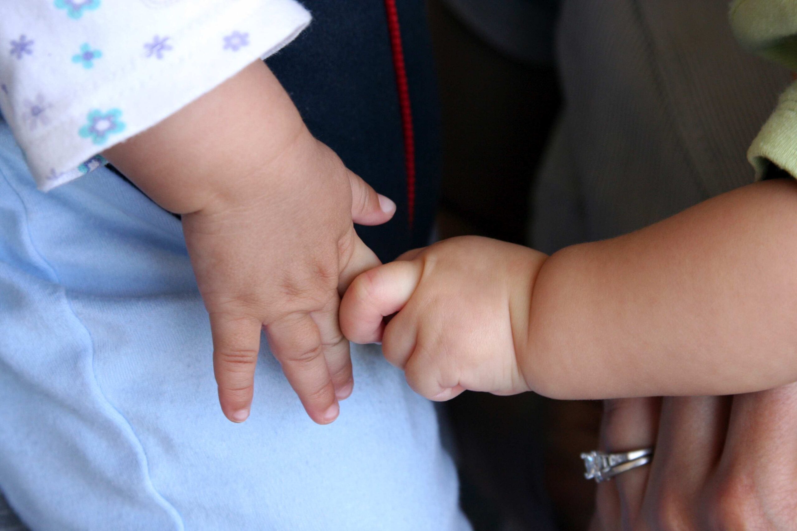 Two babies holding hands