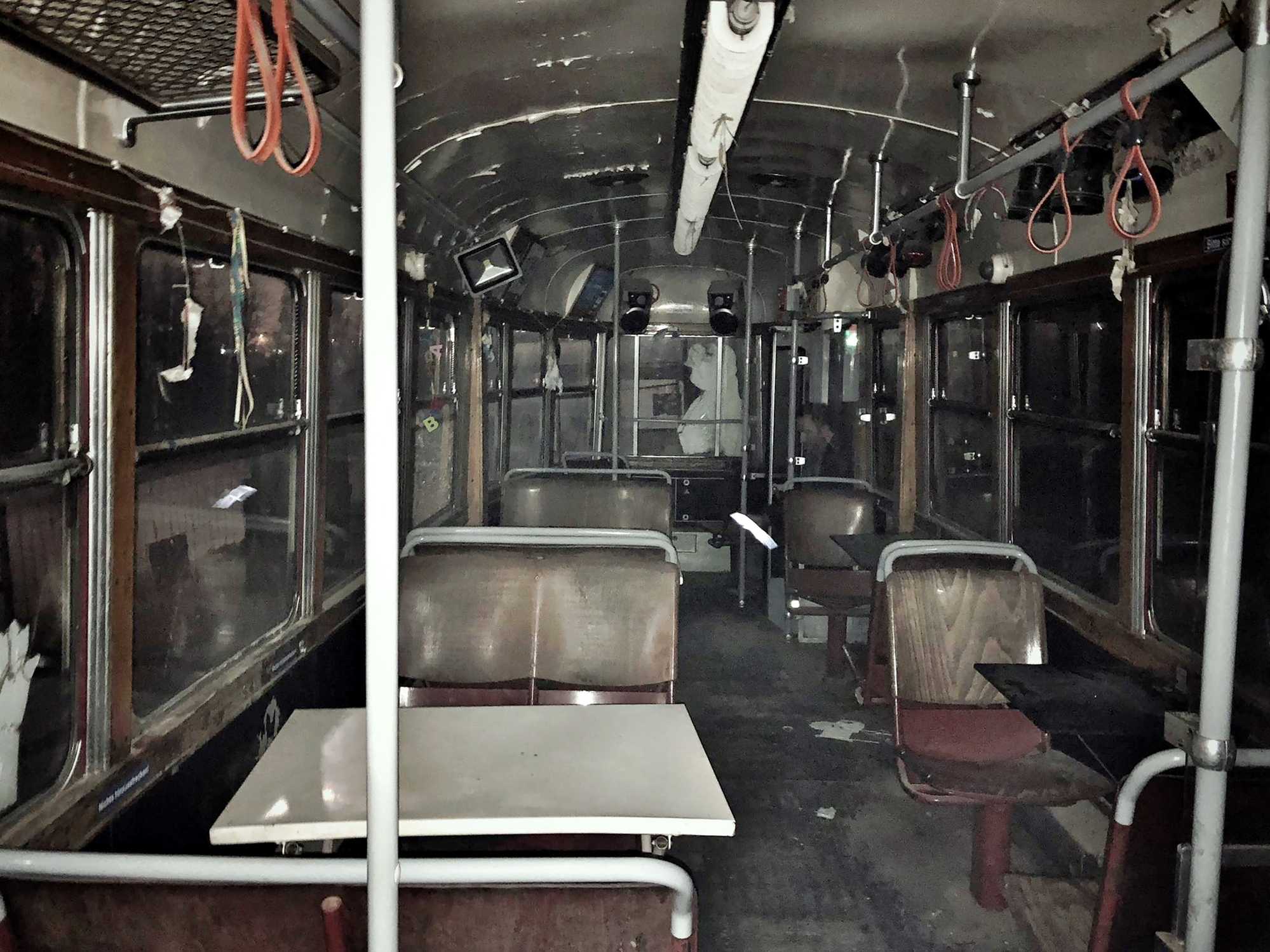 Abandoned train car with benches and tables
