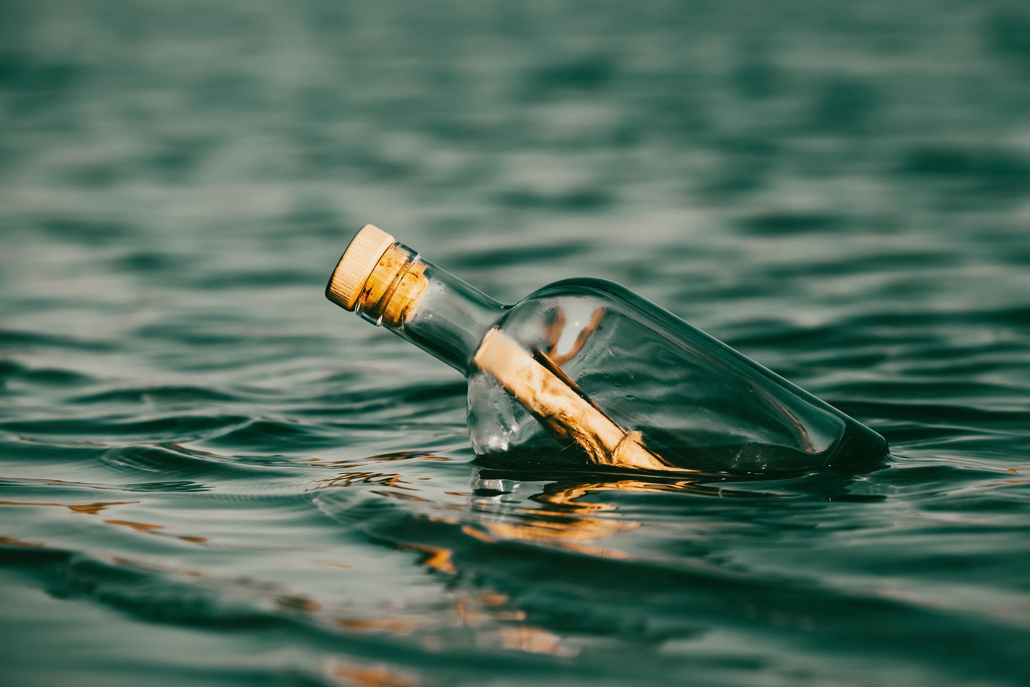Message in a bottle floating on the ocean waves.