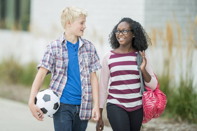 Two teens walk side by side