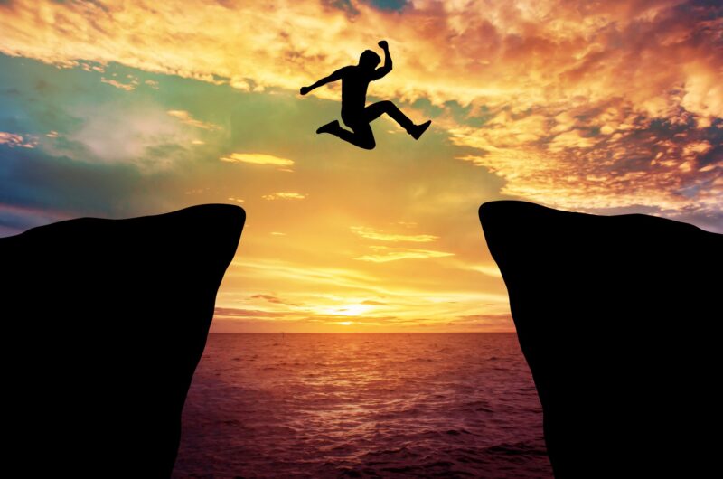 Man jump through the gap between hill.