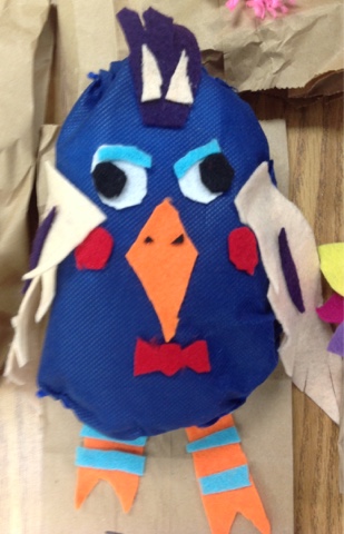 Small blue stuffed animal made from felt and yarn 