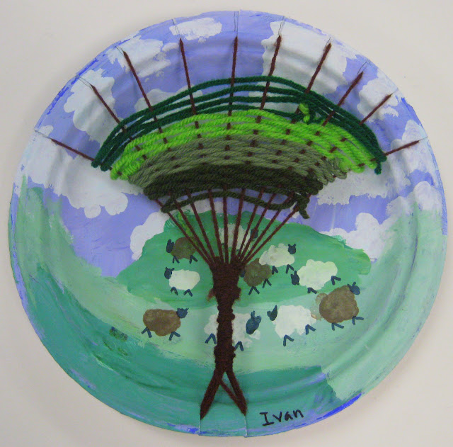 Paper Plate Tree Weaving Paper plate used to create a woven tree, with a painted background of sheep on a hill